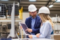 Female engineer and male director talking in modern industrial factory about solar panels - PhotoDune Item for Sale