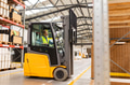 Female warehouse worker driving forklift. Warehouse worker preparing products for shipmennt - PhotoDune Item for Sale