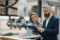 Female engineer and male production manager standing in modern industrial factory, talking about - PhotoDune Item for Sale