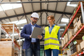 Female warehouse worker talking with production manager, discussing new order, preparing products - PhotoDune Item for Sale