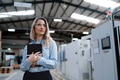 Female manager standing in modern industrial factory. Manufacturing facility with robotics and - PhotoDune Item for Sale