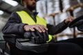 Close up of warehouse worker driving forklift. Warehouse worker preparing products for shipmennt - PhotoDune Item for Sale