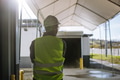 Rear view of warehouse worker waiting on loading dock for loading vehicle, delivery truck. - PhotoDune Item for Sale