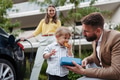 Happy young family with little son waiting for charging their electric car. - PhotoDune Item for Sale