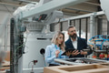 Female engineer and male project manager standing in modern industrial factory by precision robotic - PhotoDune Item for Sale