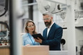 Female engineer and male supervisor standing in modern industrial factory, talking about production - PhotoDune Item for Sale