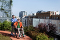 Nurse pushing senior man in wheelchair. Female caregiver and elderly man enjoying a warm autumn day - PhotoDune Item for Sale