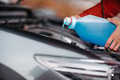 Pouring winter washer fluid into car reservoir during winter, protecting it from freezing. - PhotoDune Item for Sale