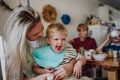 Mother feeding little baby with breakfast in home kitchen. Healthy breakfast or snack before day - PhotoDune Item for Sale