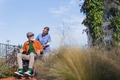 Nurse pushing senior man in wheelchair. Female caregiver and elderly man enjoying a warm autumn day - PhotoDune Item for Sale