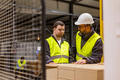 Young man with Down syndrome working in modern factory, colleague teaching him about his job - PhotoDune Item for Sale
