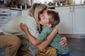 Mother saying goodbyeto to son before school, hugging, embracing him in kitchen. - PhotoDune Item for Sale