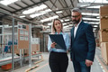 Female warehouse manager talking with logistics employee in warehouse, planning transport of - PhotoDune Item for Sale