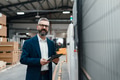 Portrait of male project manager standing in modern industrial factory. Manufacturing facility with - PhotoDune Item for Sale