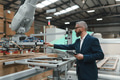 Male engineer in modern industrial factory, checking robotic arm, controling process and - PhotoDune Item for Sale