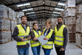 Full team of warehouse employees standing in warehouse. Team of workers in reflective clothing in - PhotoDune Item for Sale