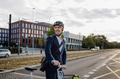 Handsome middle-aged man commuting through the city by bike, walking next to bike crossing the road - PhotoDune Item for Sale