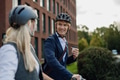 Colleagues commuting through the city, buying, drinking coffe in front of office. Middle-aged city - PhotoDune Item for Sale