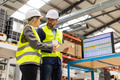 Female engineer and male project manager standing in modern industrial factory, talking about - PhotoDune Item for Sale