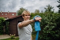 Middle aged man doing strength exercises with resistance band outdoors in garden. Concept of workout - PhotoDune Item for Sale
