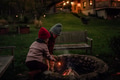 The family spending evening outdoors, lighting fire in a fire pit. Prents and kids spending quality - PhotoDune Item for Sale