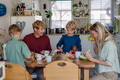 Family eating breakfast together in home kitchen. Healthy breakfast or snack before kindergarden - PhotoDune Item for Sale