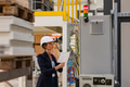 Female manager standing in modern industrial factory. Manufacturing facility with robotics and - PhotoDune Item for Sale