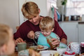 Father feeding little baby with breakfast in home kitchen. Boy spreading jam on his bread. Healthy - PhotoDune Item for Sale
