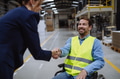 Portrait of man in wheelchair working in warehouse, shaking hand with HR manager, director. Concept - PhotoDune Item for Sale