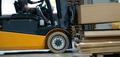 Close up of forklift working in warehouse. Industrial lift truck, jitney lifting and moving - PhotoDune Item for Sale