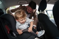 Young father gvinig his little son in car seat. - PhotoDune Item for Sale