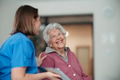 Portrait of nurse and senior patient talking in hospital corridor. Emotional support for elderly - PhotoDune Item for Sale