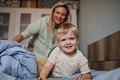 Portrait of little baby boy waking up in the morning. Mother helping son out of bed. - PhotoDune Item for Sale