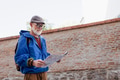 Senior tourist exploring new city, interesting places. Elderly man holding paper map, looking for - PhotoDune Item for Sale