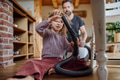Father and daughter cleaning house, vacuuming the floors with a vacuum cleaner. Young girl helping - PhotoDune Item for Sale