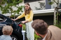 Happy young family with little son waiting for charging their electric car. - PhotoDune Item for Sale