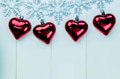 Snowflakes and heart ornaments hanging on white wood background - PhotoDune Item for Sale