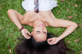 Young happy and smiling woman laying down on green grass - PhotoDune Item for Sale