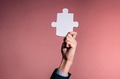 Business man giving the missing piece of jigsaw - PhotoDune Item for Sale