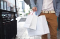 Shopaholic man walking on commercial street with a lot of shopping bags - PhotoDune Item for Sale