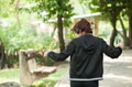 Young woman listening and dancing to the music in the park - PhotoDune Item for Sale