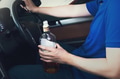 Man holding a bottle of liquor while driving in vintage tone - PhotoDune Item for Sale