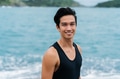 Young happy smiling man nearby the sea and looking at the camera - PhotoDune Item for Sale