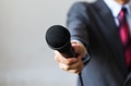 Man in business suit holding a microphone - PhotoDune Item for Sale