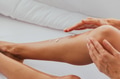 Caucasian female spreading smooth cream on soft legs skin while sitting on comfortable bed at home - PhotoDune Item for Sale