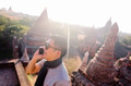 Young man talking on the phone in rural and temple pagoda area - PhotoDune Item for Sale