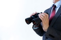 Businessman looking for something with binoculars - PhotoDune Item for Sale