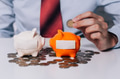 Young man collecting money coins and allocate coins into categories - PhotoDune Item for Sale
