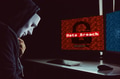 Masked hacker under hood using computer to commit data breach crime - PhotoDune Item for Sale