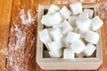 Sugar Cubes in Square Shaped Bowl with Unrefined Sugar spill over in Wooden Background - PhotoDune Item for Sale